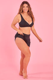 Model Laura wearing size 14 of the Swim Skirt in colour Black (Black), from the front, showing the whole outfit