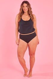 Model Laura wearing size 14 of the Retro High Waist Pant in colour Black (Black), from the front, showing the whole outfit