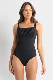 A model wearing the Basix Dd/E Square Neck One Piece in colour Black (Black), from the front, showing the whole outfit