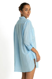 A model wearing the Summer Stripe Painters Shirt in colour Teal (Green), from the back