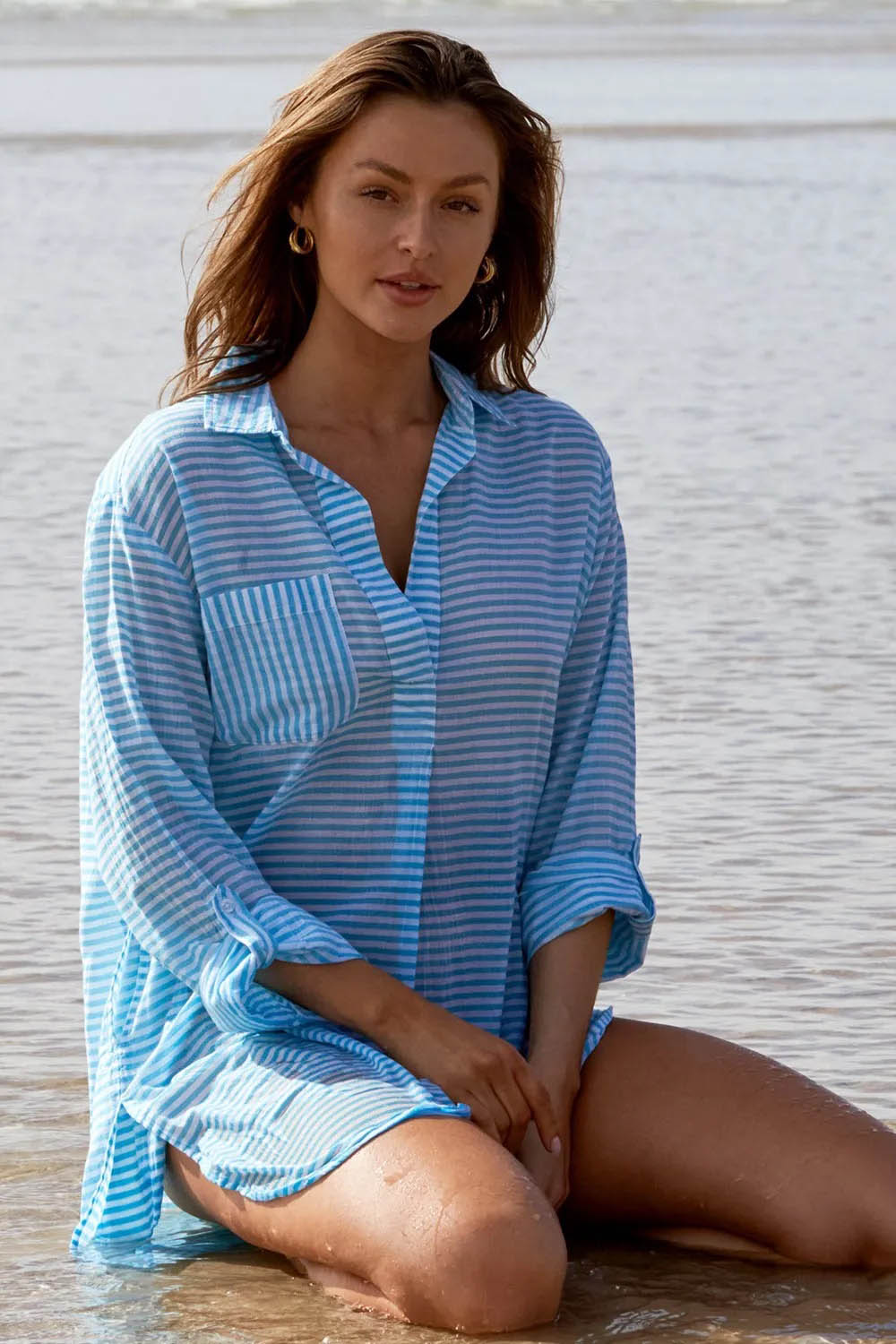 A model wearing the Summer Stripe Painters Shirt in colour Teal (Green), from the front, showing the whole outfit