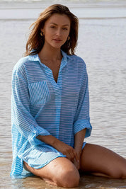 A model wearing the Summer Stripe Painters Shirt in colour Teal (Green), from the front, showing the whole outfit
