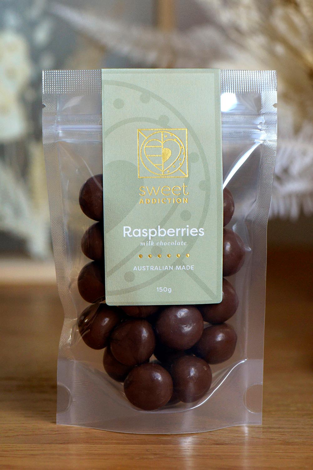 Product shot of the 150g Milk Chocolate Raspberries - Milkrasp in colour Milkrasp, from the front
