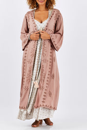 Model Summer wearing size OneSize of the Lorenzo Cape in colour RoseSmoke (Pink), from the front, cropped image