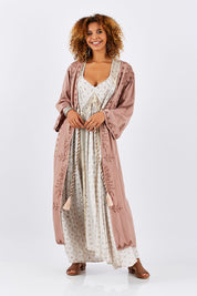 Model Summer wearing size OneSize of the Lorenzo Cape in colour RoseSmoke (Pink), from the front, showing the whole outfit