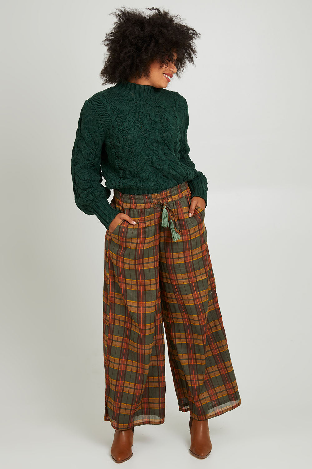 Model Olivia wearing size S of the Freedom Pant in colour Highlands, from the front, showing the whole outfit