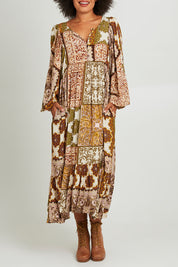 Model Olivia wearing the Mira Dress in colour Paisleygar, from the front, cropped image