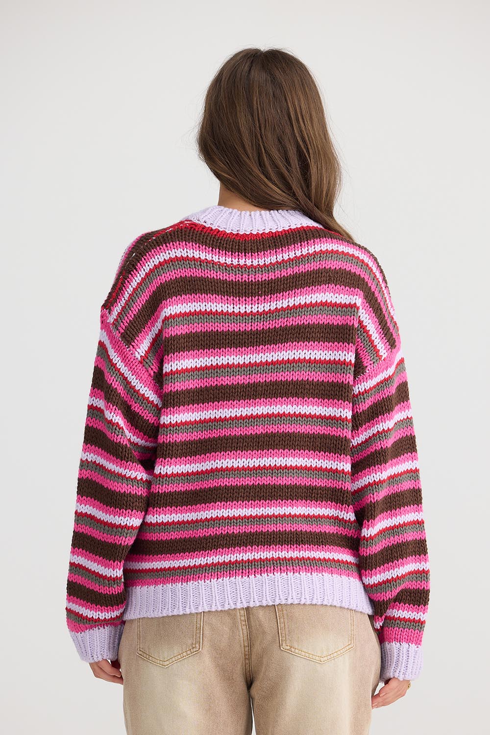 A model wearing the All Sorts Knit in colour Lilacstrip, from the back