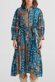 A model wearing the Castella Cotton Dress in colour Sicilian (Blue), from the front, cropped image