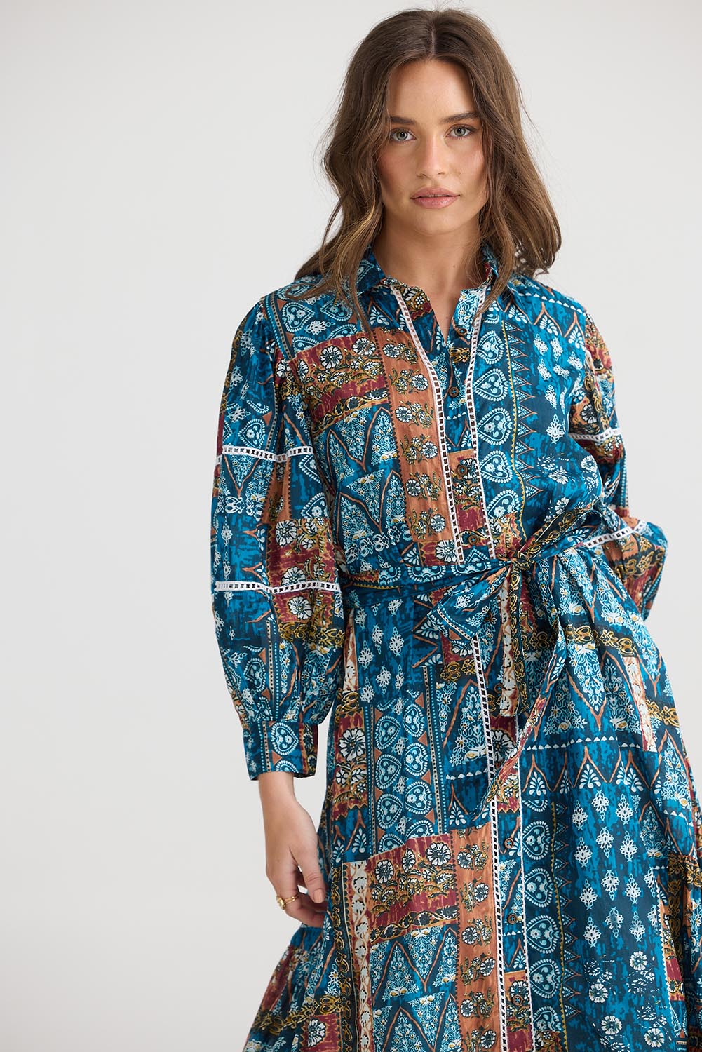 A model wearing the Castella Cotton Dress in colour Sicilian (Blue), from the front, cropped image