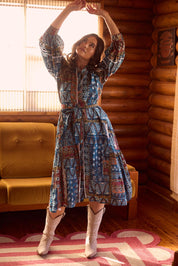A model wearing the Castella Cotton Dress in colour Sicilian (Blue), from the front, showing the whole outfit