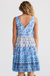 A model wearing the Lucky Charm Cotton Dress in colour Blueberry (Blue), from the back