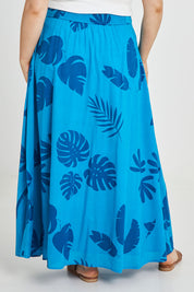 Model Keeara wearing size 16 of the Rosie Maxi Skirt in colour Palm (Blue), from the back
