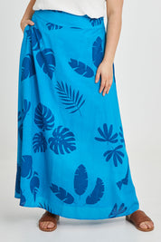 Model Keeara wearing size 16 of the Rosie Maxi Skirt in colour Palm (Blue), from the front, cropped image