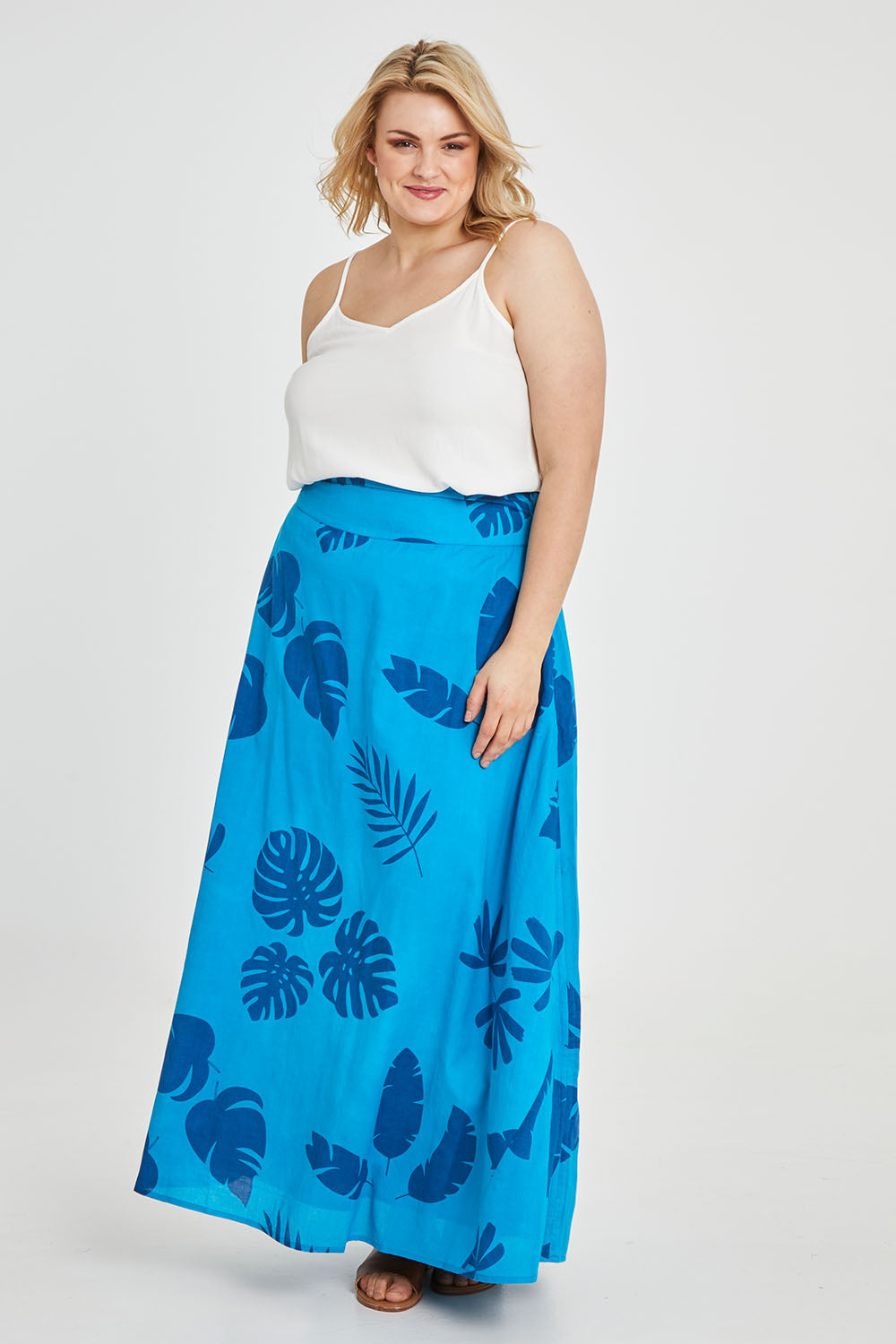 Model Keeara wearing size 16 of the Rosie Maxi Skirt in colour Palm (Blue), from the front, showing the whole outfit
