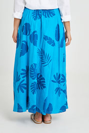 Model Terri-Leigh wearing size 14 of the Rosie Maxi Skirt in colour Palm (Blue), from the back
