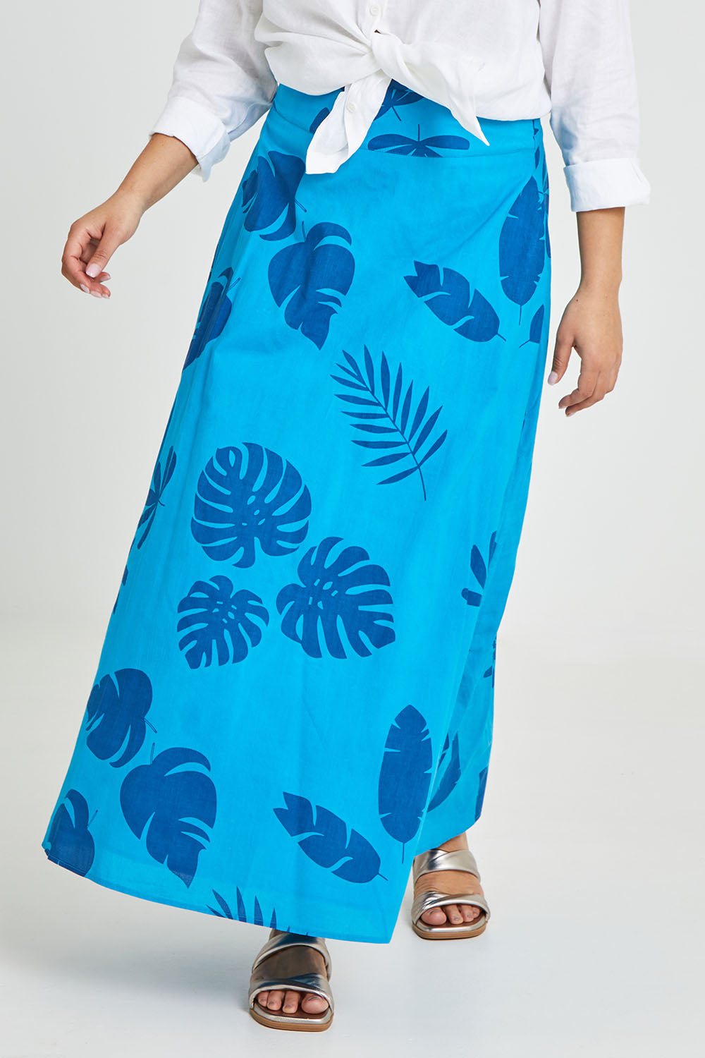 Model Terri-Leigh wearing size 14 of the Rosie Maxi Skirt in colour Palm (Blue), from the front, cropped image