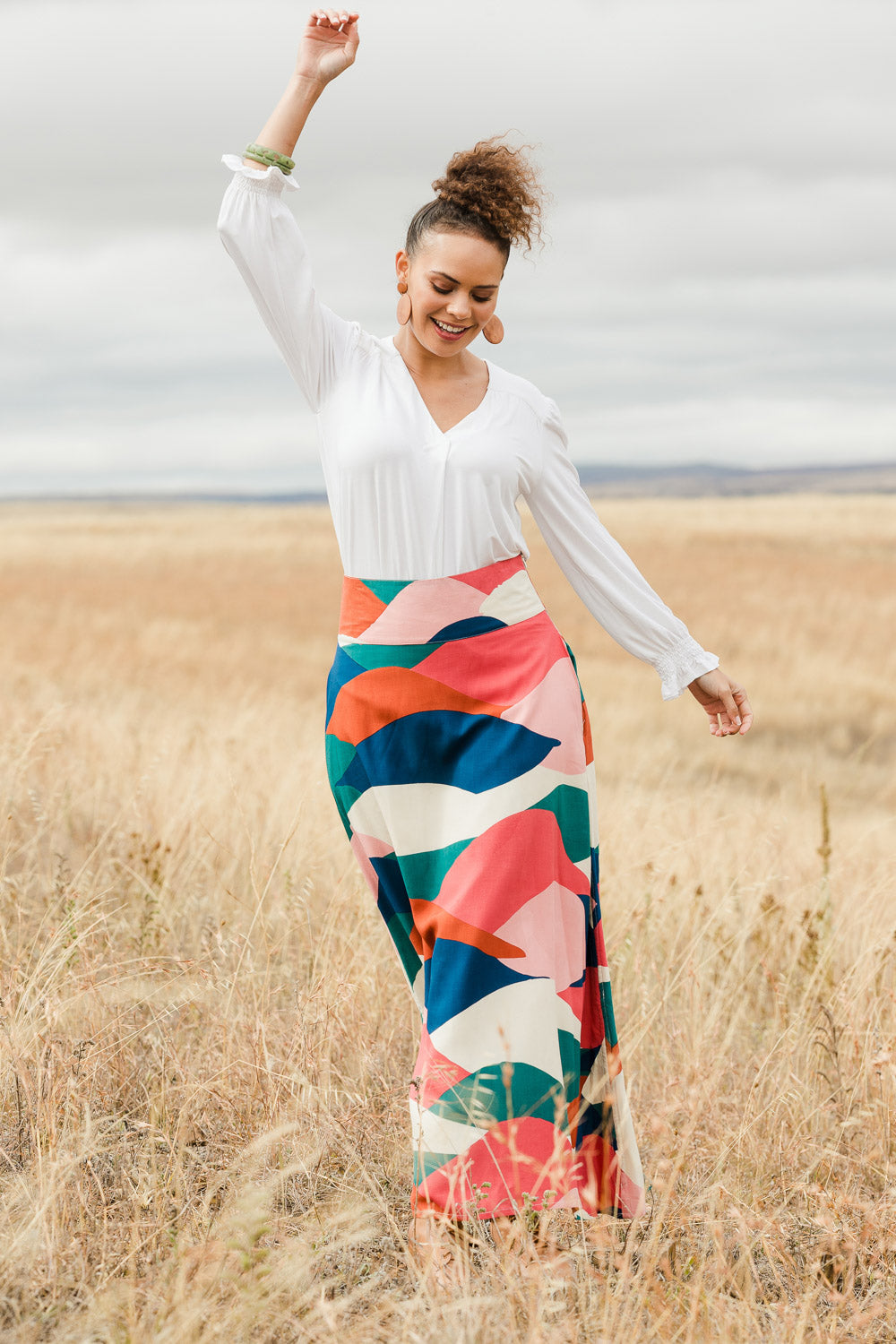 Model Lala wearing size 10 of the Rosie Maxi Skirt in colour Horizon (Pink), from the front, showing the whole outfit
