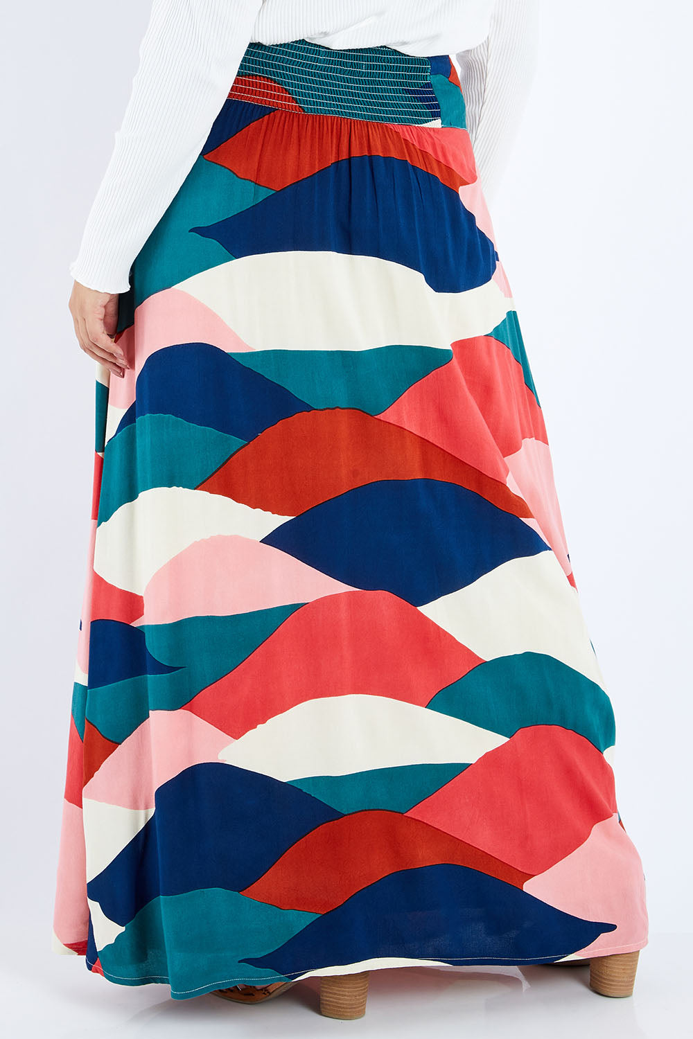 Model Sasha-Lee wearing size 16 of the Rosie Maxi Skirt in colour Horizon (Pink), from the back