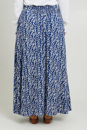 Model Monique wearing size 14 of the Rosie Maxi Skirt in colour Forest (Blue), from the back