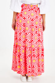 Model Courtney wearing size 10 of the Mallory Tier Skirt in colour Pinkdaisy (Pink), from the back