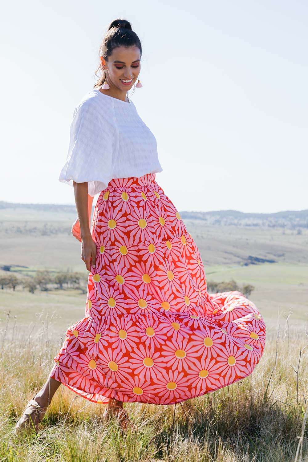 Model Vitoria wearing size 10 of the Mallory Tier Skirt in colour Pinkdaisy (Pink), from the front, showing the whole outfit