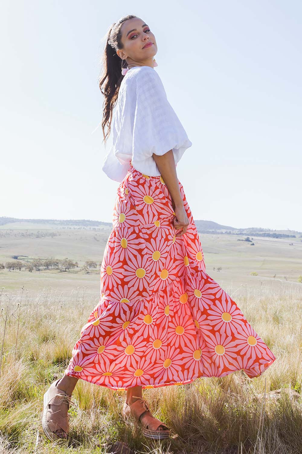 Model Vitoria wearing size 10 of the Mallory Tier Skirt in colour Pinkdaisy (Pink), from the front, showing the whole outfit