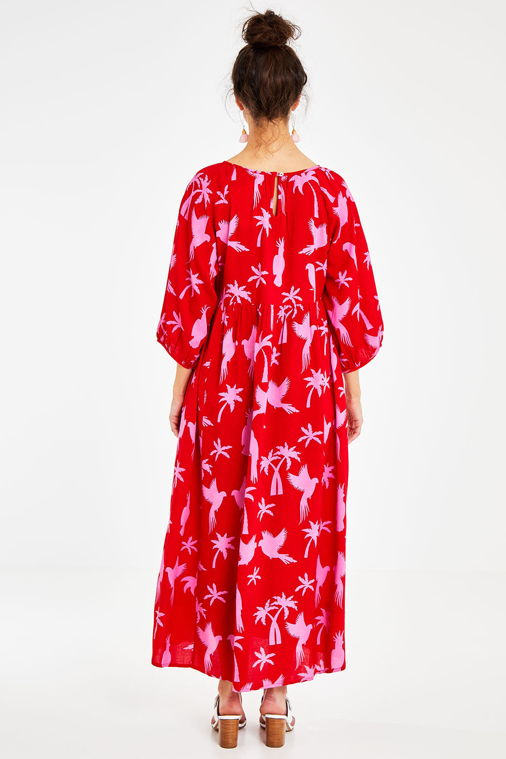 Model Courtney wearing size 10 of the Alice Gathered Dress in colour Bird (Red), from the back