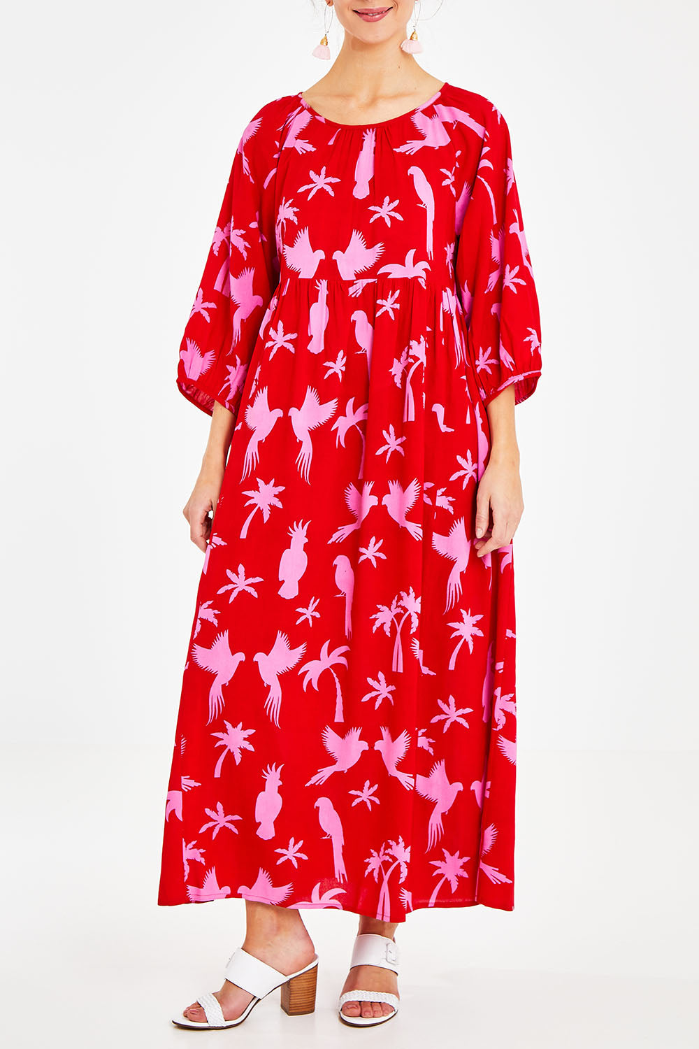 Model Courtney wearing size 10 of the Alice Gathered Dress in colour Bird (Red), from the front, cropped image