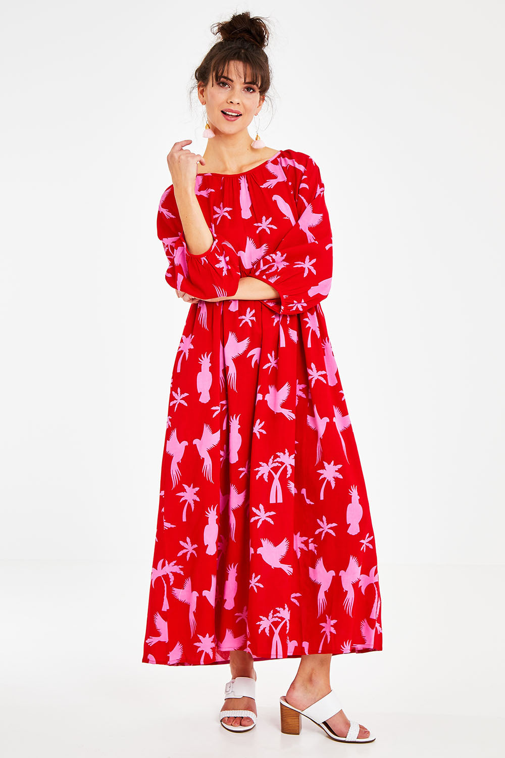 Model Courtney wearing size 10 of the Alice Gathered Dress in colour Bird (Red), from the front, showing the whole outfit