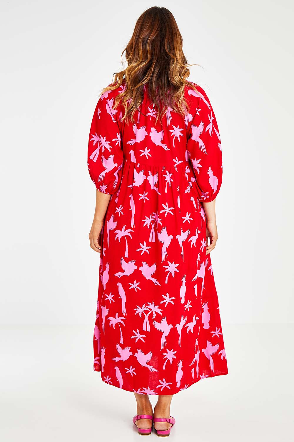 Model Laura wearing size 14 of the Alice Gathered Dress in colour Bird (Red), from the back