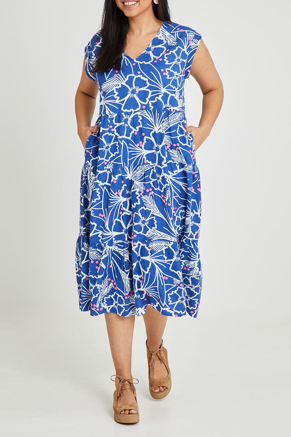 Model Terri-Leigh wearing size 14 of the Madison Tiered Dress in colour Bloom (Blue), from the front, cropped image