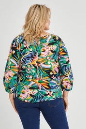 Model Keeara wearing size 16 of the Julia 3/4 Sleeve Top in colour Rainforest (Blue), from the back