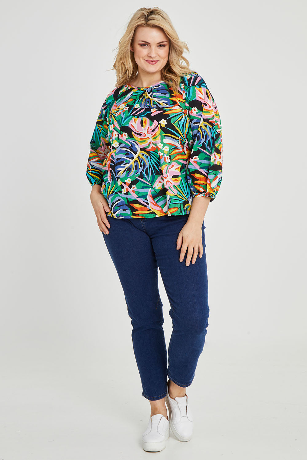 Model Keeara wearing size 16 of the Julia 3/4 Sleeve Top in colour Rainforest (Blue), from the front, showing the whole outfit