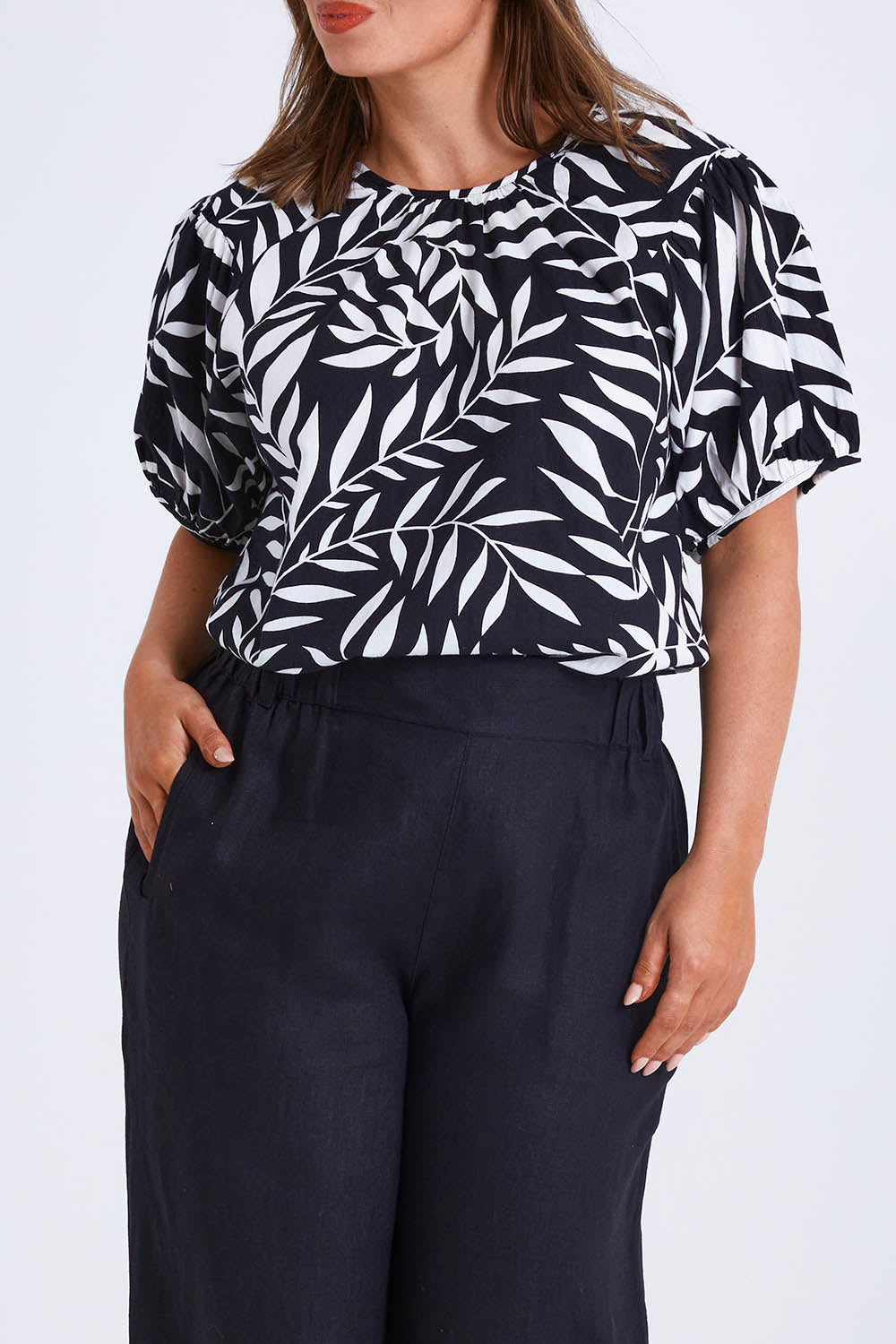 Model Monique wearing size 14 of the Rachel Bell Sleeve Top in colour Vines (Black), from the front, cropped image