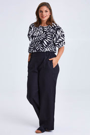 Model Monique wearing size 14 of the Rachel Bell Sleeve Top in colour Vines (Black), from the front, showing the whole outfit