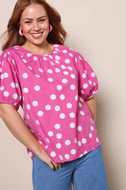 Model Georgiel wearing size 10 of the Rachel Cotton Top – Pinkspot in colour Pinkspot, from an angle