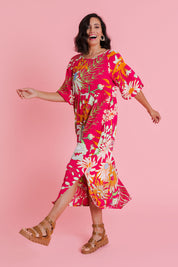 Model Natalie wearing size 10 of the Isabella Dress in colour Garden (Pink), from the front, showing the whole outfit