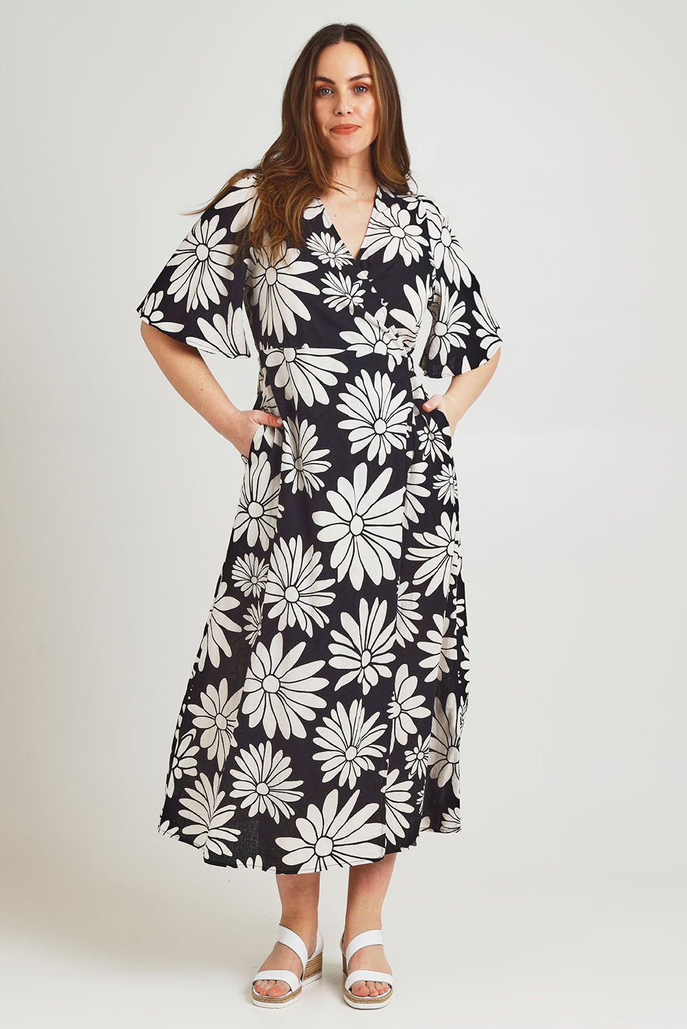 Model Jane wearing size 14 of the Gloria Cotton Wrap Dress in colour Bolddaisy (Black), from the front, showing the whole outfit