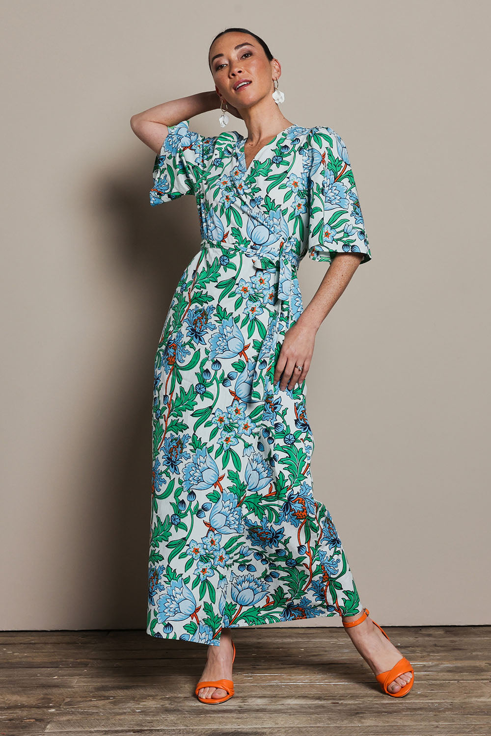 Model Katie wearing size 10 of the Gloria Cotton Wrap Dress in colour Thistle, from the front, showing the whole outfit