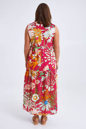 Model Monique wearing size 14 of the Monica Maxi Dress in colour Garden (Pink), from the back