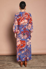 Model Katie wearing size 10 of the Daphne Maxi Wrap Dress in colour Gardenblue (Blue), from the back