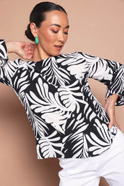 Model Katie wearing size 10 of the Harriet Blouse in colour Fern (Black), from the front, cropped image