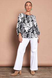 Model Katie wearing size 10 of the Harriet Blouse in colour Fern (Black), from the front, showing the whole outfit
