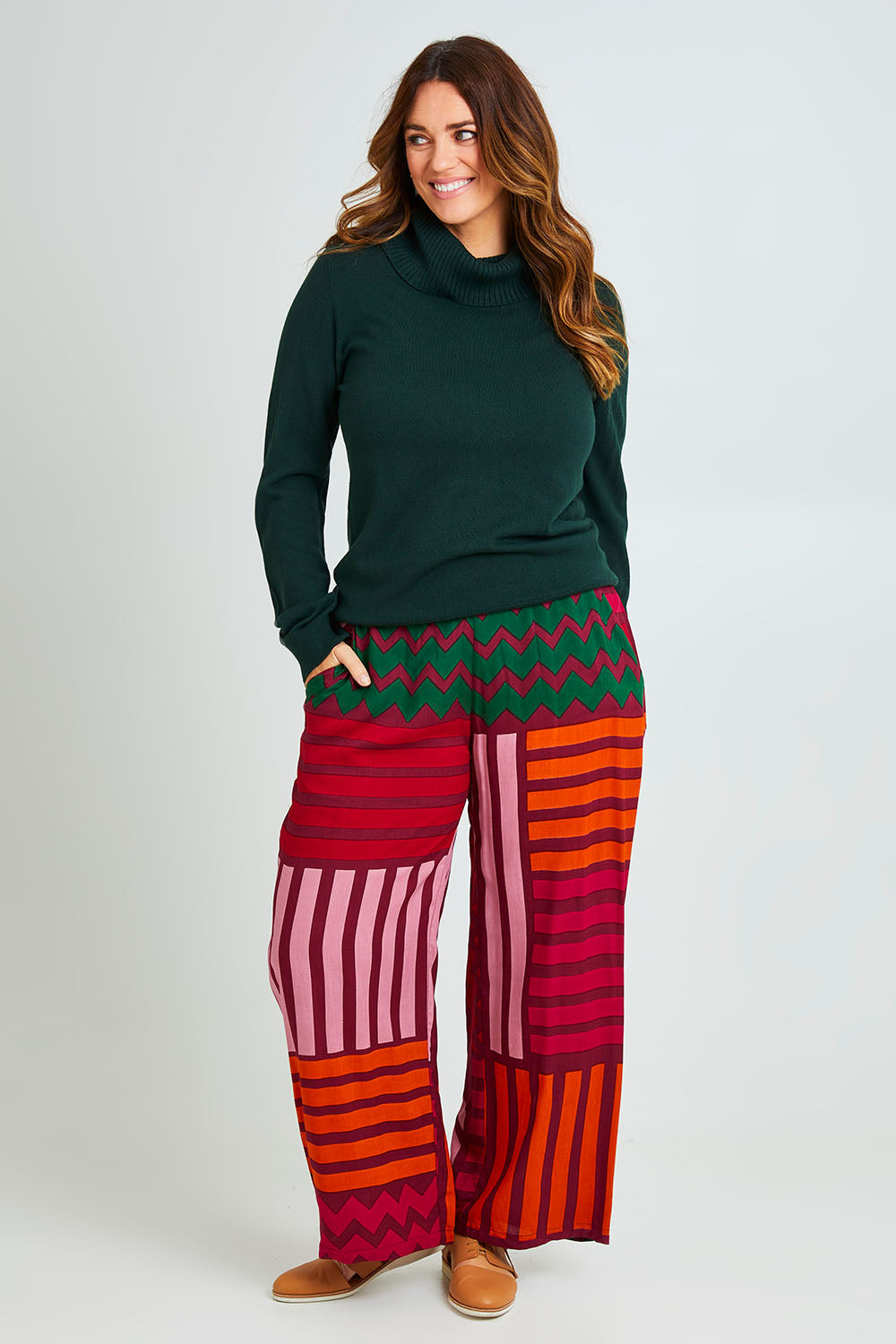Model Laura wearing size 14 of the Andie Pant in colour Lines (Pink), from the front, showing the whole outfit