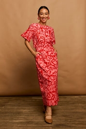 Model Katie wearing size 10 of the Camilla Cotton Scalloped Hem Skirt in colour Flowerpop (Red), from the front, showing the whole outfit