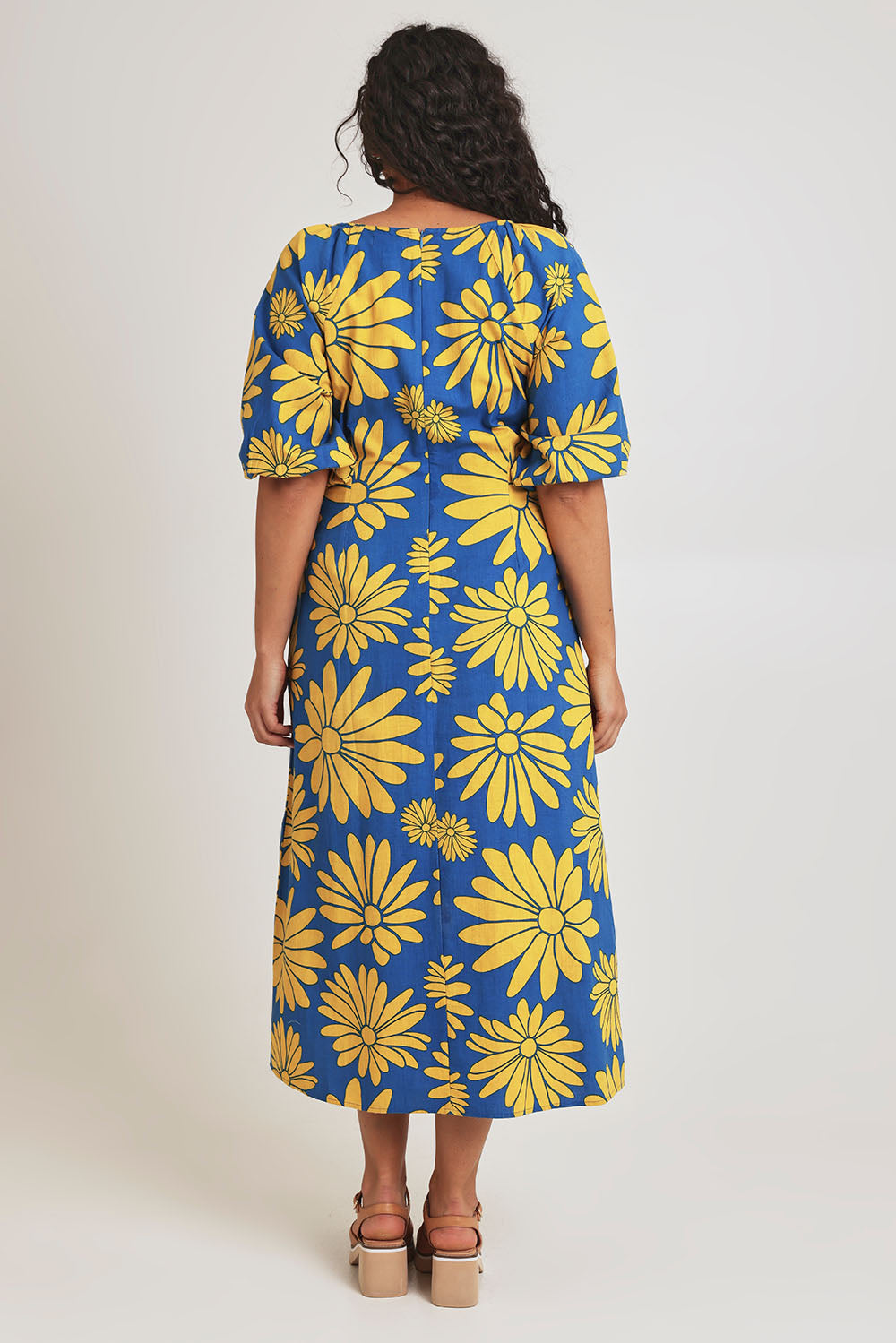 Model Terri-Leigh wearing size 14 of the Brooke Cotton V Neck Dress in colour Bolddaisy (Blue), from the back