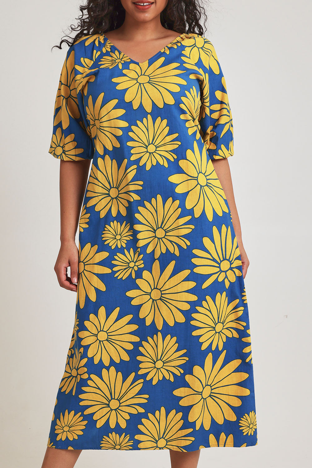 Model Terri-Leigh wearing size 14 of the Brooke Cotton V Neck Dress in colour Bolddaisy (Blue), from the front, cropped image
