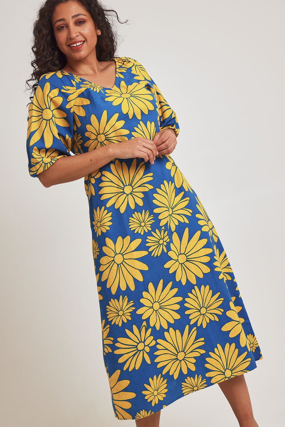 Model Terri-Leigh wearing size 14 of the Brooke Cotton V Neck Dress in colour Bolddaisy (Blue), from the front, cropped image