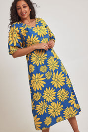 Model Terri-Leigh wearing size 14 of the Brooke Cotton V Neck Dress in colour Bolddaisy (Blue), from the front, cropped image